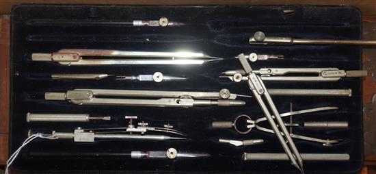 A cased set of drawing instruments by A G Thornton, four various cased slide rules and two bookslides,